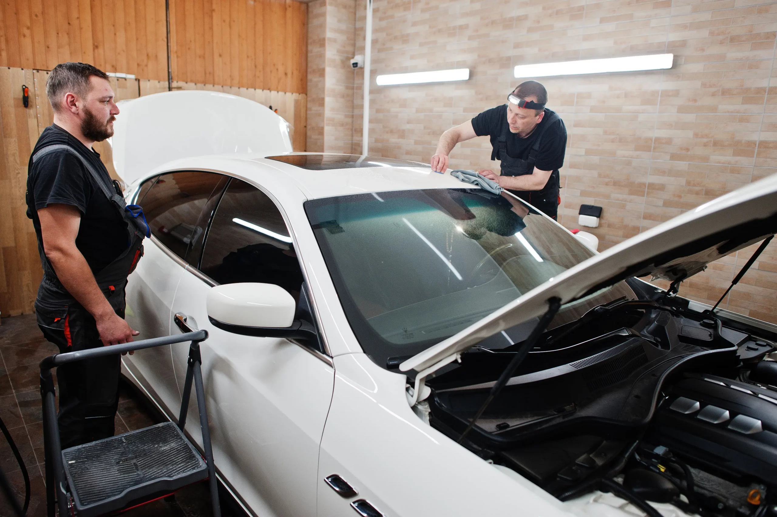Worker in detailing garage put polyurethane anti-gravel film cov
